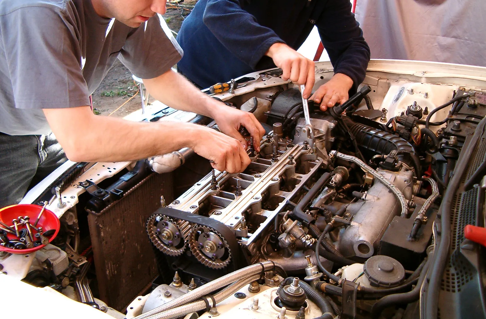Two mechanics doing regeneration services on a diesel engine