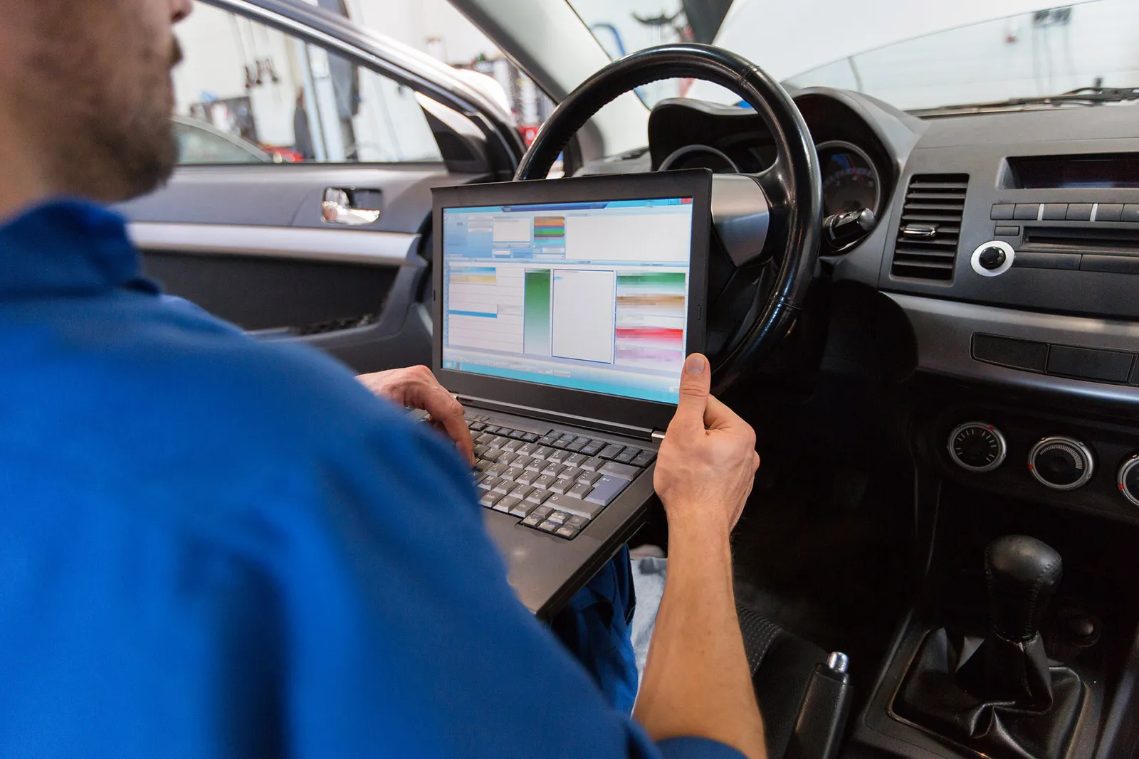 Mechanic checking faults on a diagnostic tool