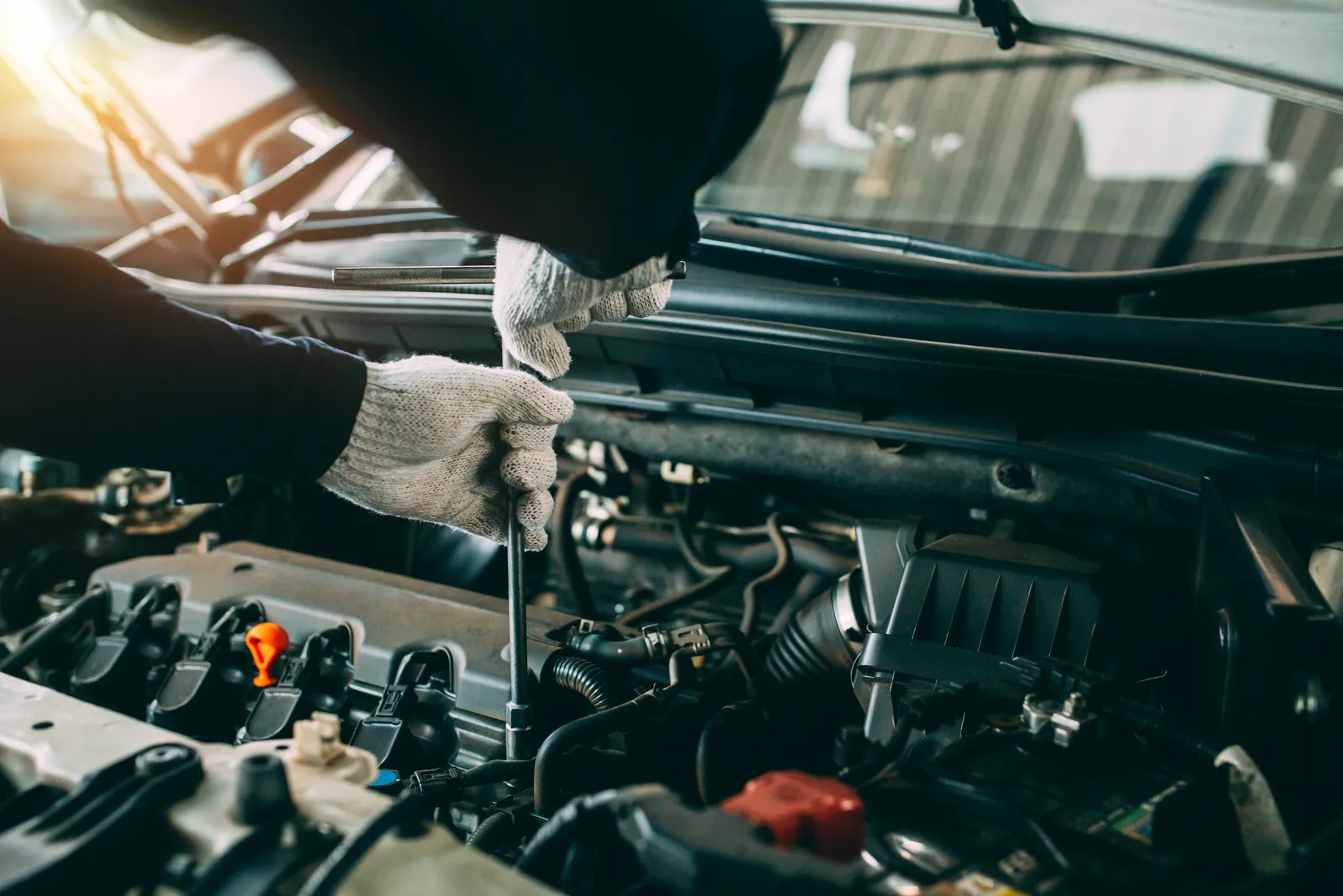 Trusted mechanic working on the front of the car