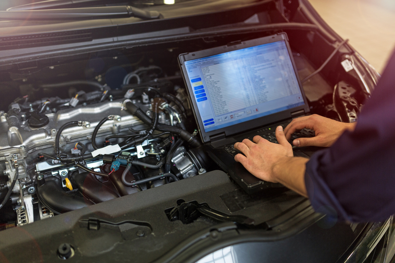 Mechanic checking for faults inside a car